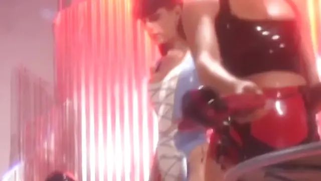 Latex masked subs teased by lesbian domina