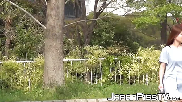 A cameraman films shy girls needing to pee outside