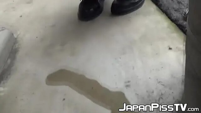 Young Asian redhead pees on the street